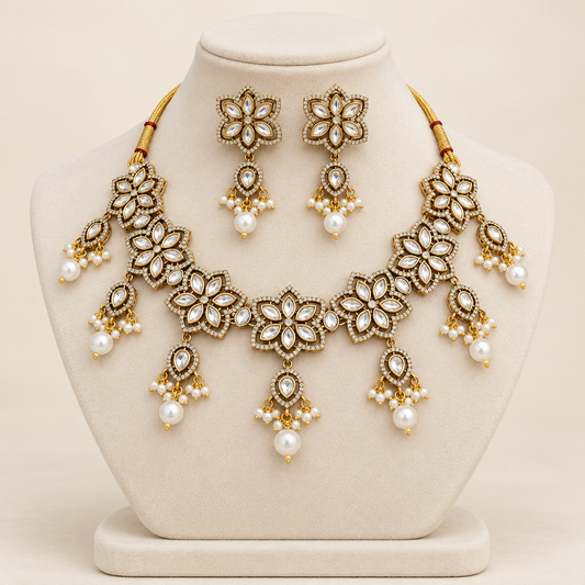 Navraee Anya Antique Floral Polki Necklace Set with Pearls and earrings on an ivory display bust