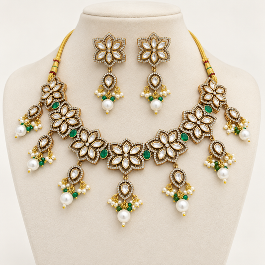 Navraee Kundan and Emerald Green Floral Necklace Set with earrings on an ivory jewelry display bust