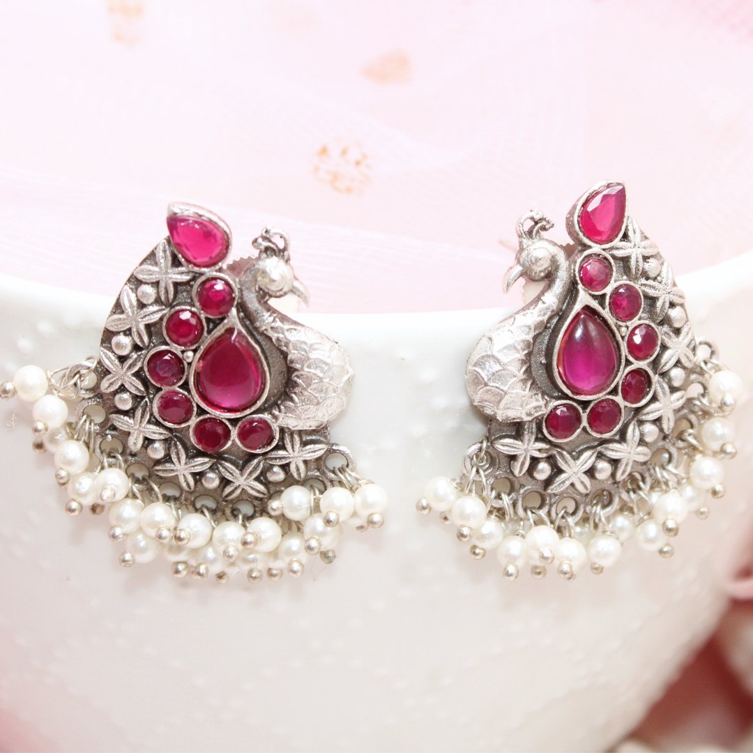 SILVER LOOK ALIKE PEACOCK STUDS - RED