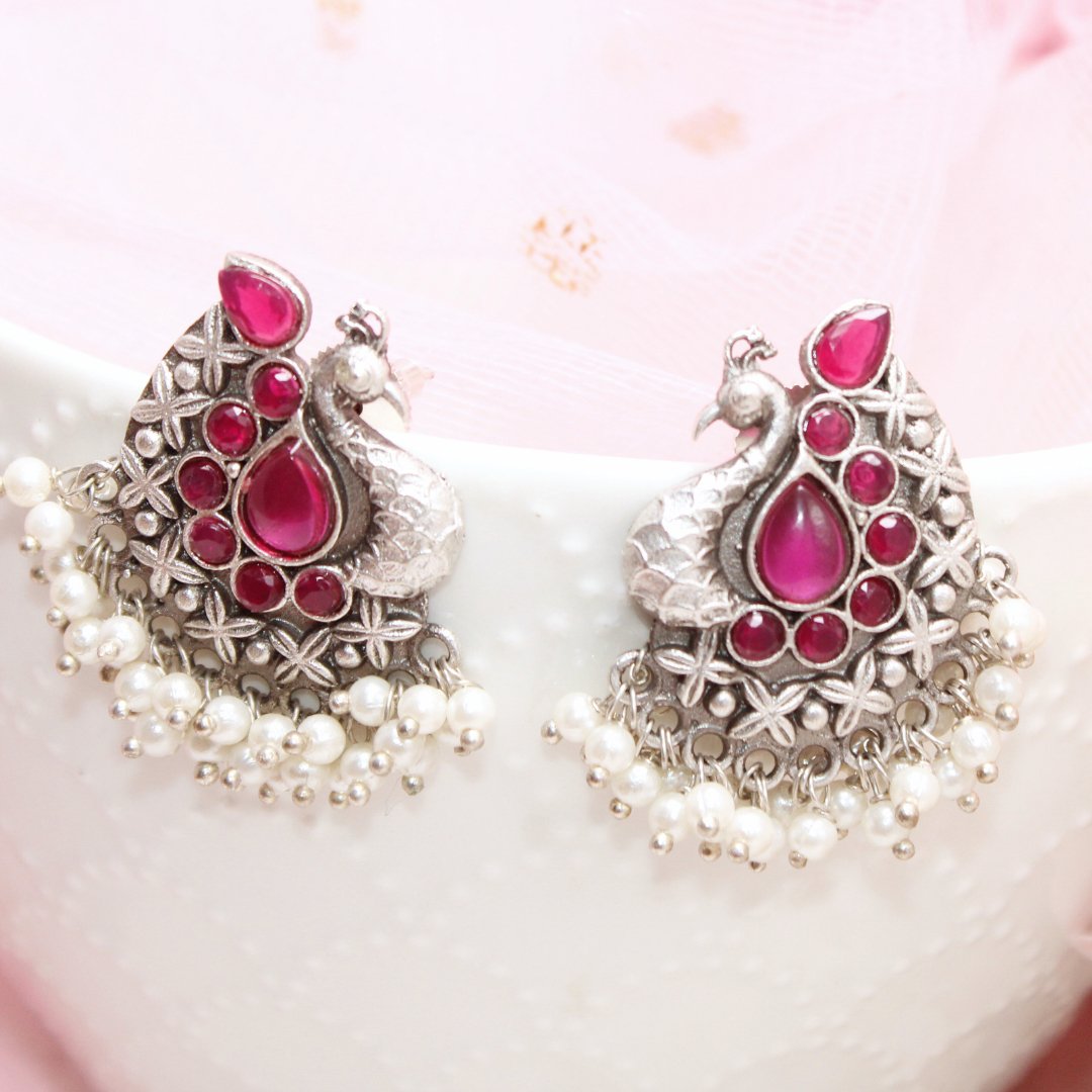 SILVER LOOK ALIKE PEACOCK STUDS - RED