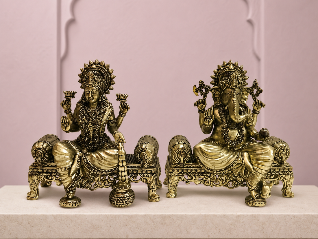 Lakshmi Ganesha brass idol pair on detailed thrones against a soft mauve backdrop