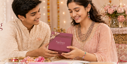 A promotional banner for Navraae Rakhi Gifting, showing a young couple smiling as the girl presents a maroon jewelry box to the boy. Below, four inset images showcase various silver and multicolor Rakhi designs and jewelry pieces.