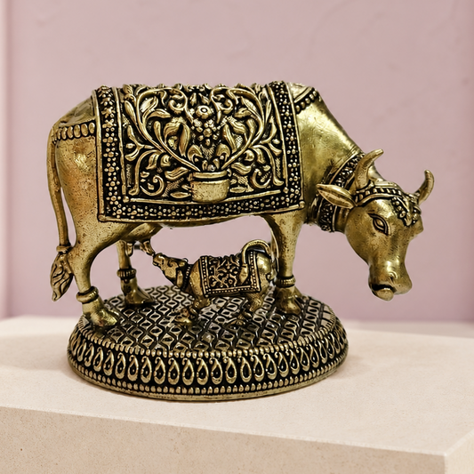 Cow and Calf Brass Idol on an ivory platform with a soft mauve heritage backdrop
