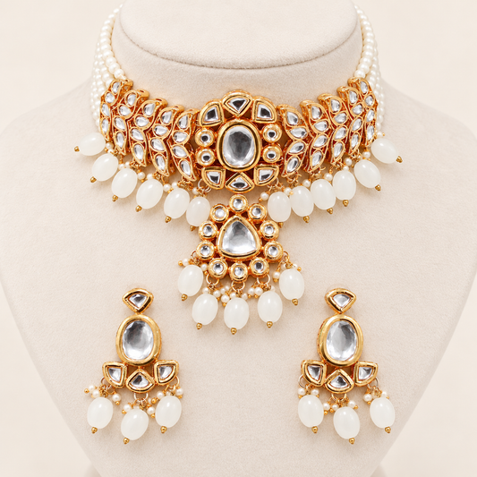 Navraee Polki Pearl Choker Necklace Set with matching drop earrings on a clean ivory display bust
